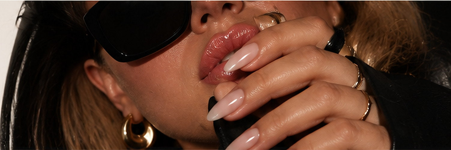 Model in sunglasses and gold hoop earrings